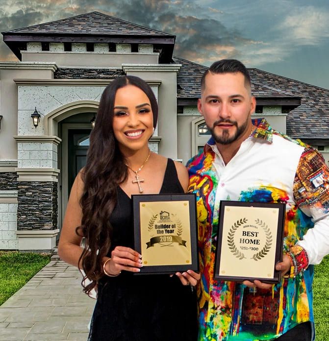 Mario Treviño, owner, holding Parade of Homes award plaques